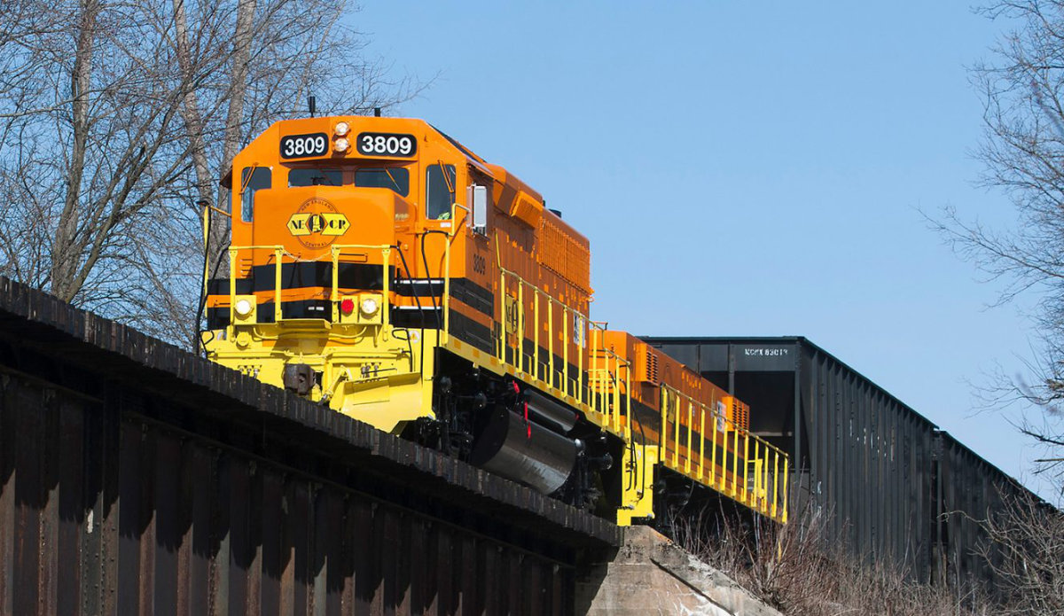 New England Central Railroad train crossing bridge.